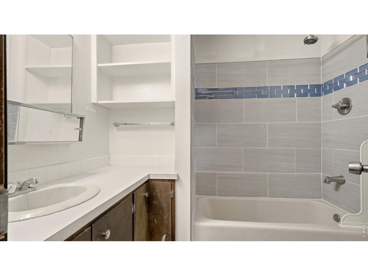 914 Prospect Street Fort Morgan, CO 80701 - Photo 10 of 17 a bathroom with a sink a bath tub a mirror and a shower