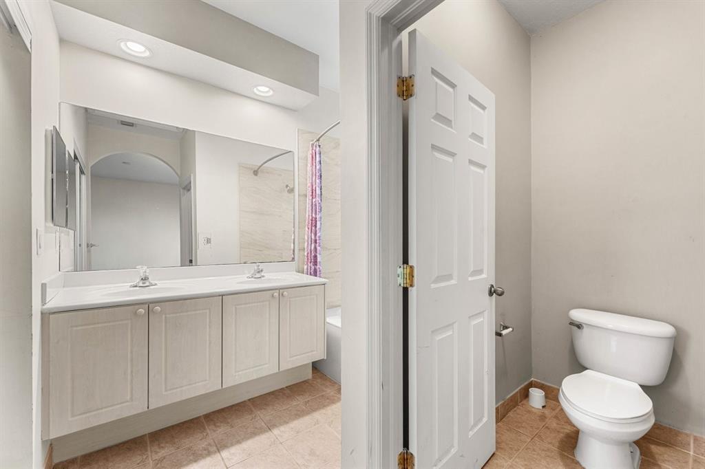 3307 Merrick Lane, Unit 1004 Margate, FL 33063 - Photo 21 of 30 a bathroom with a toilet sink and mirror