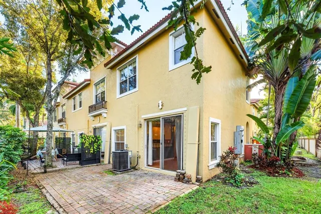 a view of a backyard with a tree