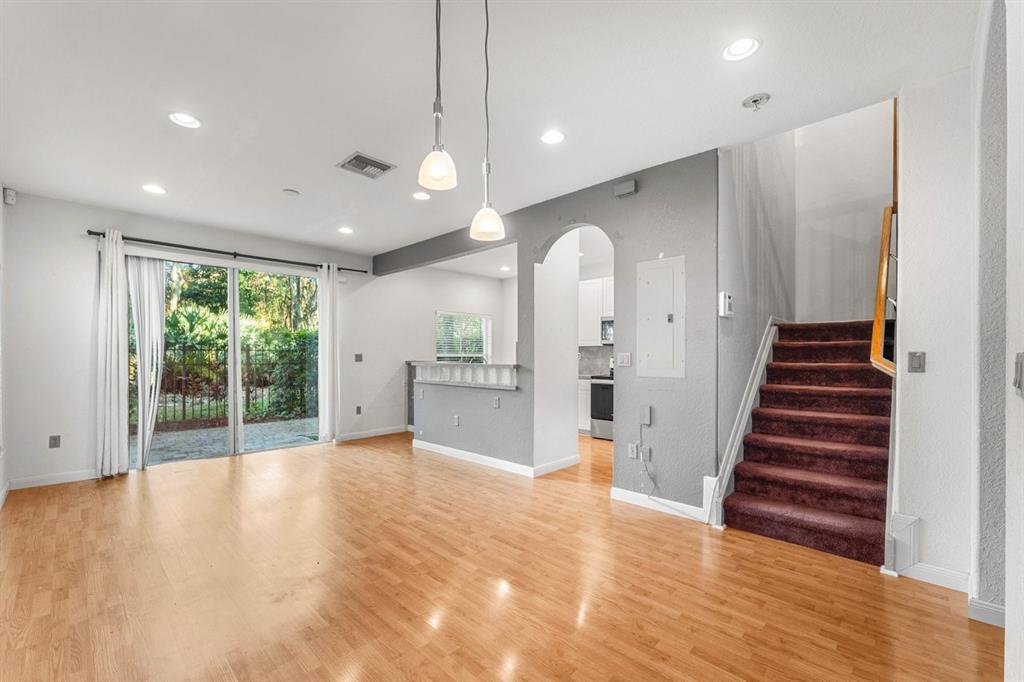 3307 Merrick Lane, Unit 1004 Margate, FL 33063 - Photo 3 of 30 a view of a big room with wooden floor and windows
