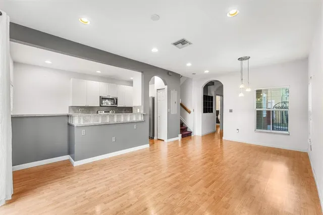 a kitchen with stainless steel appliances a stove a microwave sink and cabinets
