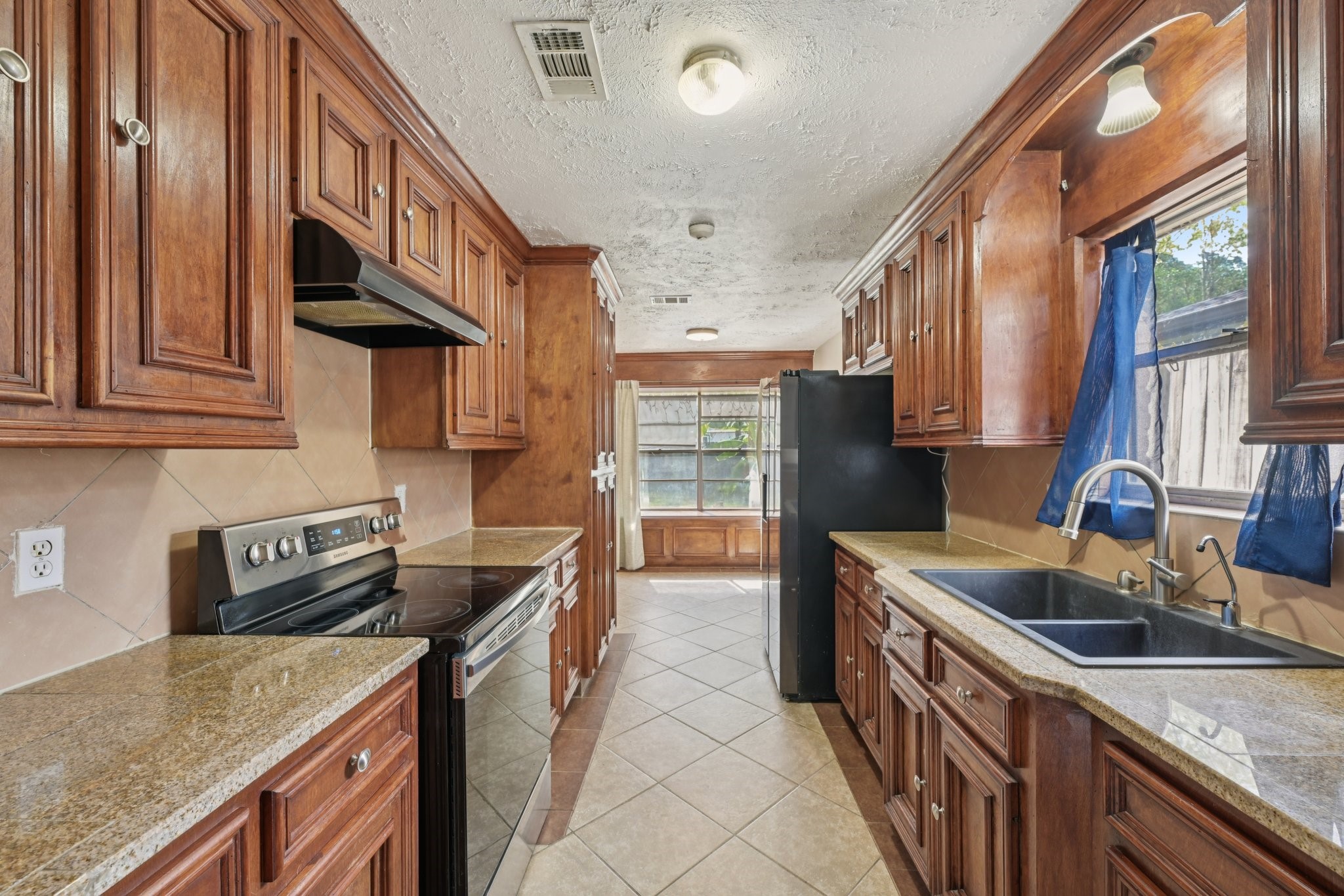 4310 Towergate Drive Spring, TX 77373 - Photo 16 of 46 a kitchen that has a sink and a stove