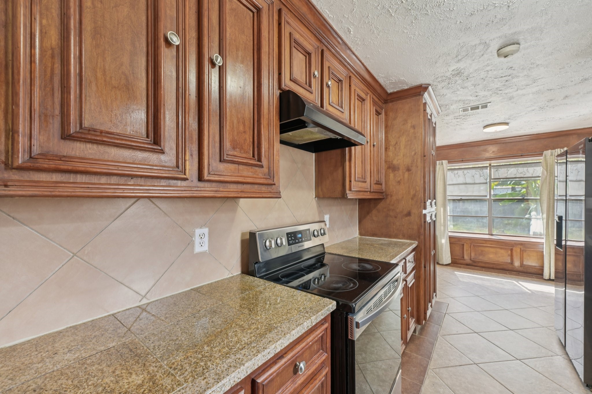 4310 Towergate Drive Spring, TX 77373 - Photo 17 of 46 a kitchen with stainless steel appliances granite countertop a sink and a stove