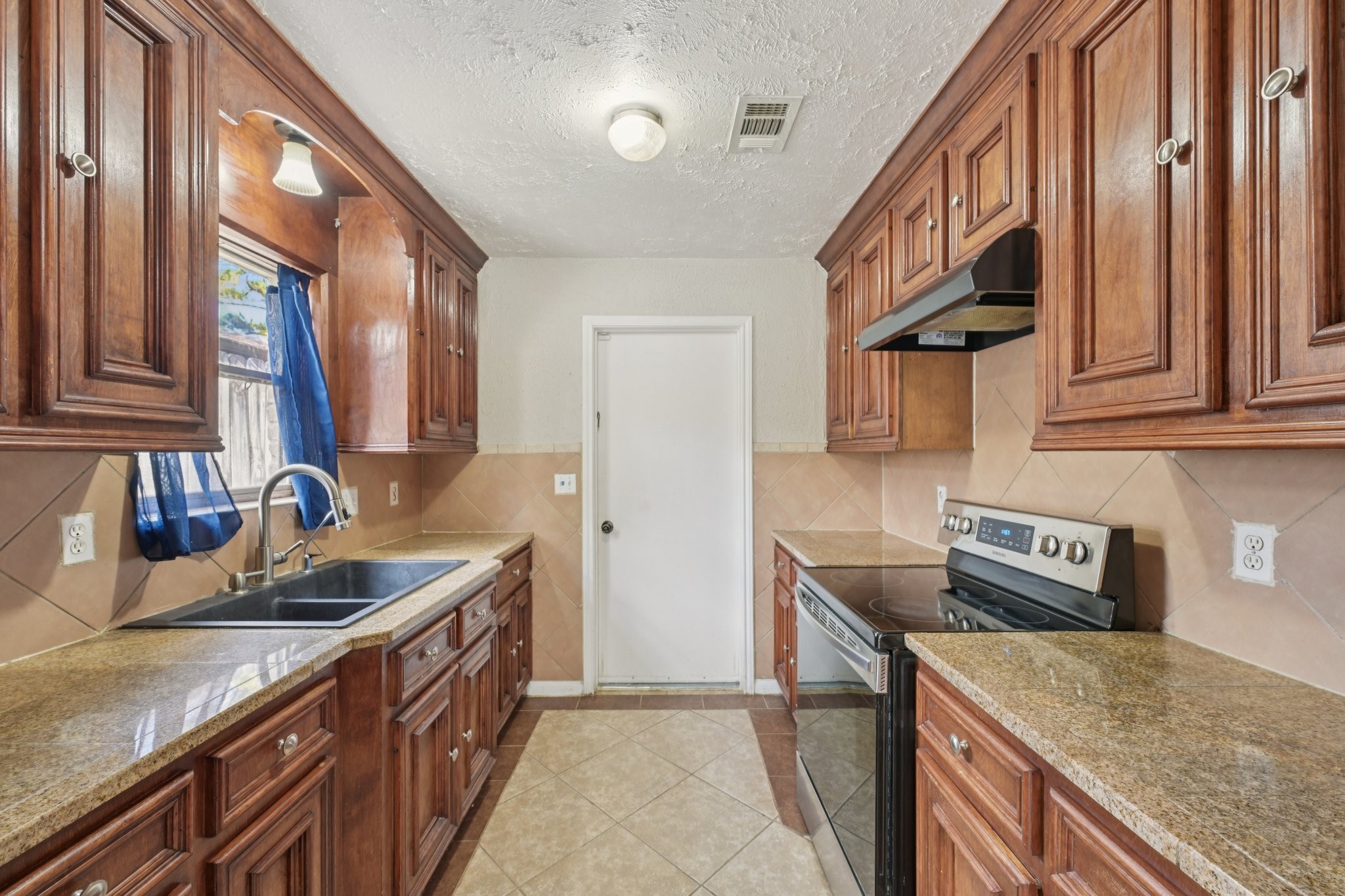 4310 Towergate Drive Spring, TX 77373 - Photo 18 of 46 a kitchen with stainless steel appliances granite countertop a sink stove and refrigerator