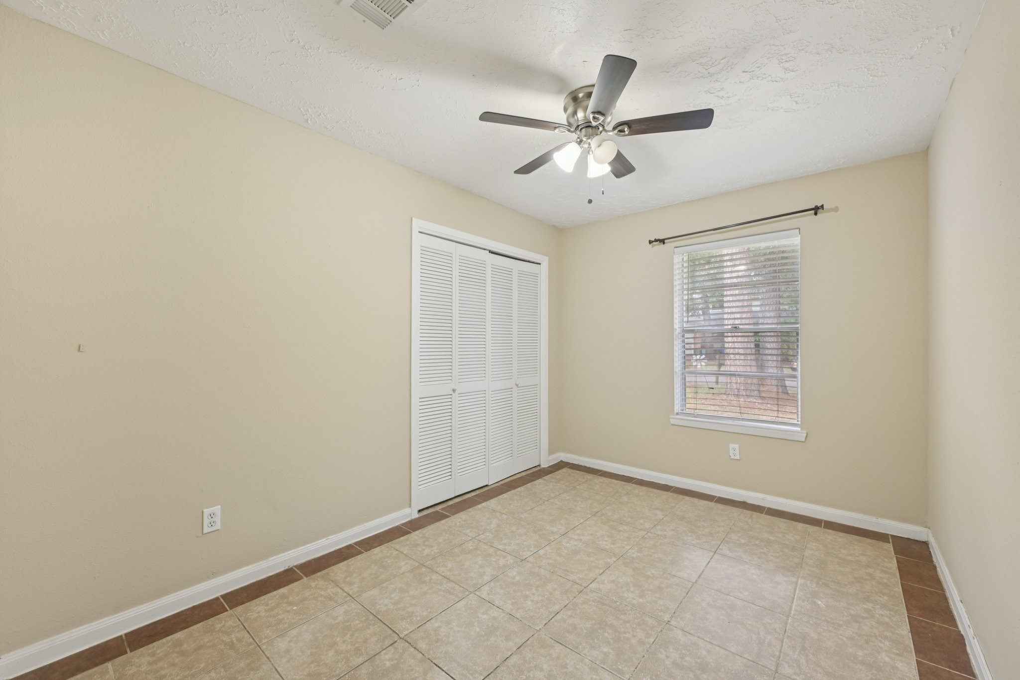 4310 Towergate Drive Spring, TX 77373 - Photo 23 of 46 an empty room with windows and fan