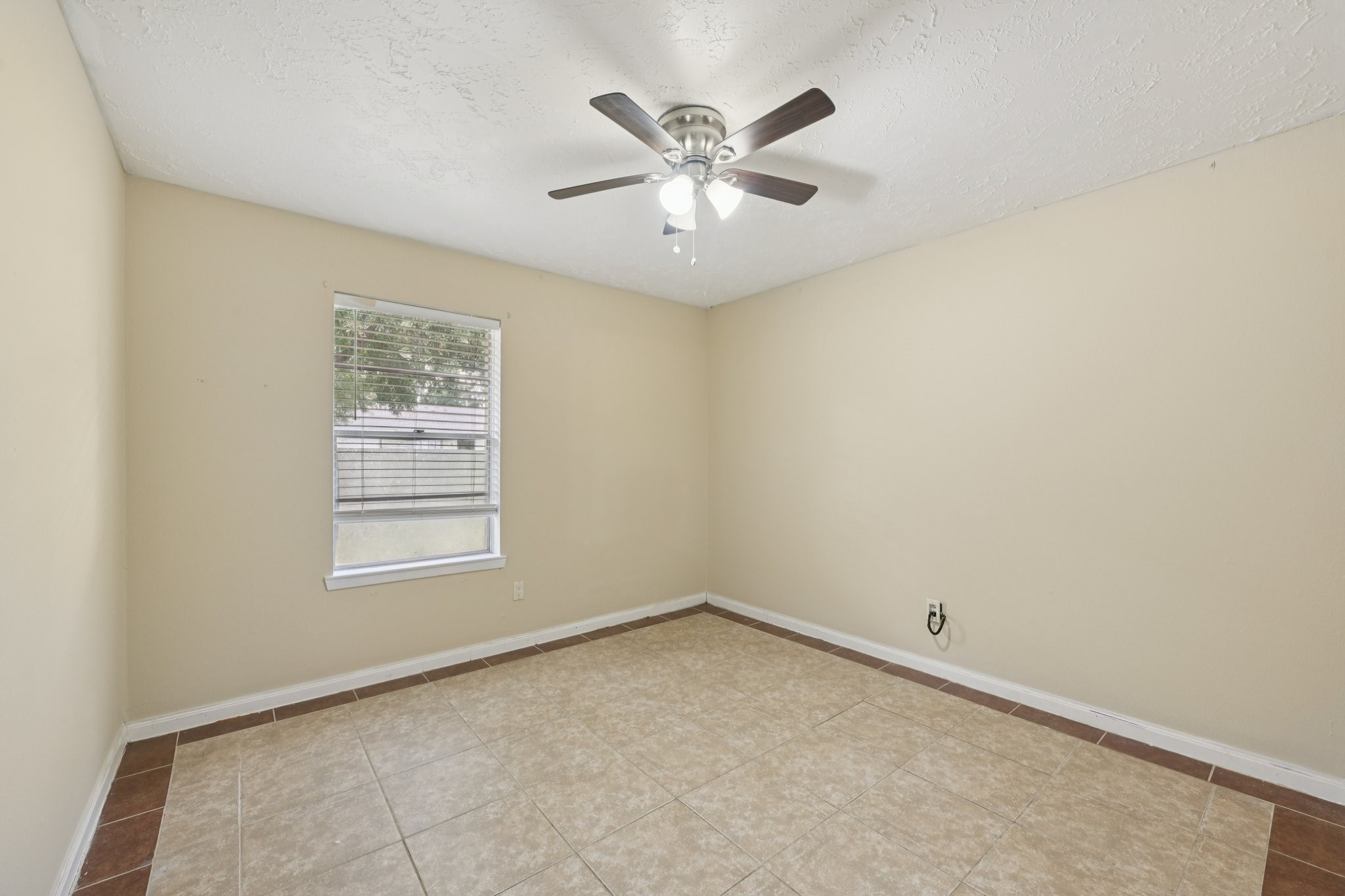 4310 Towergate Drive Spring, TX 77373 - Photo 25 of 46 an empty room with a ceiling fan and window