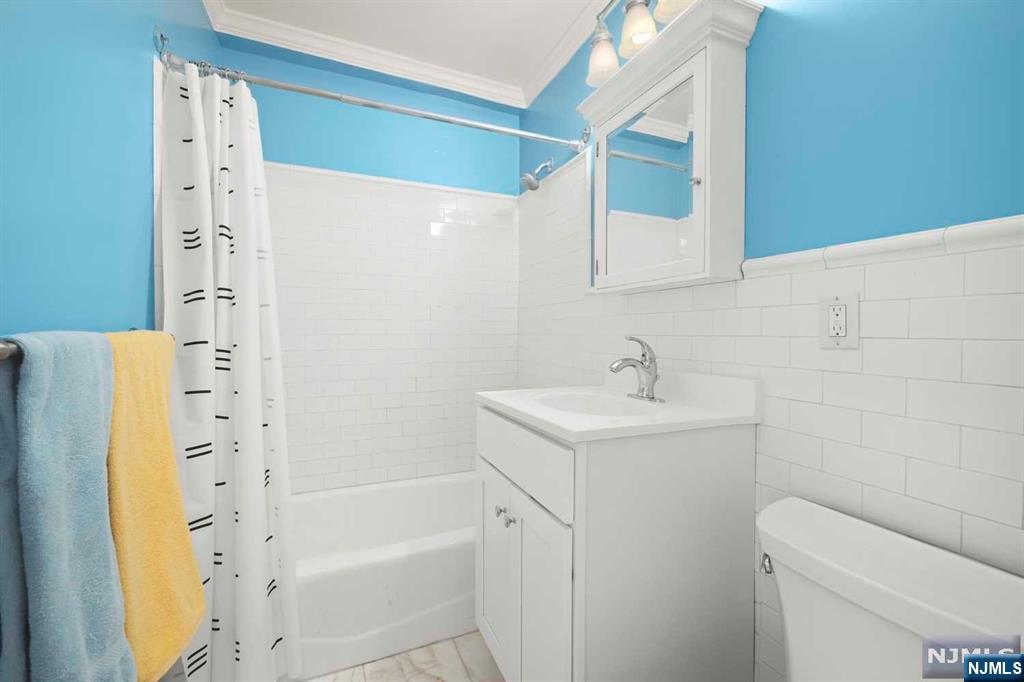 1375 River Road, Unit 4D Edgewater, NJ 07020 - Photo 18 of 25 a bathroom with a sink a toilet and shower