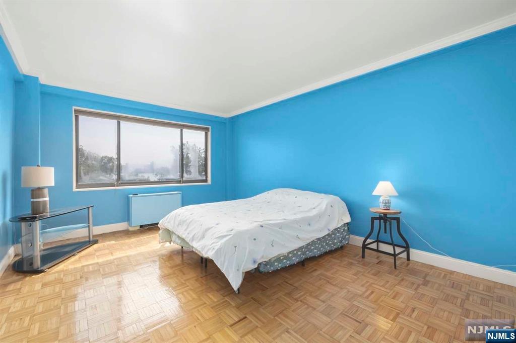 1375 River Road, Unit 4D Edgewater, NJ 07020 - Photo 19 of 25 a bedroom with a bed and a lamp next to a window