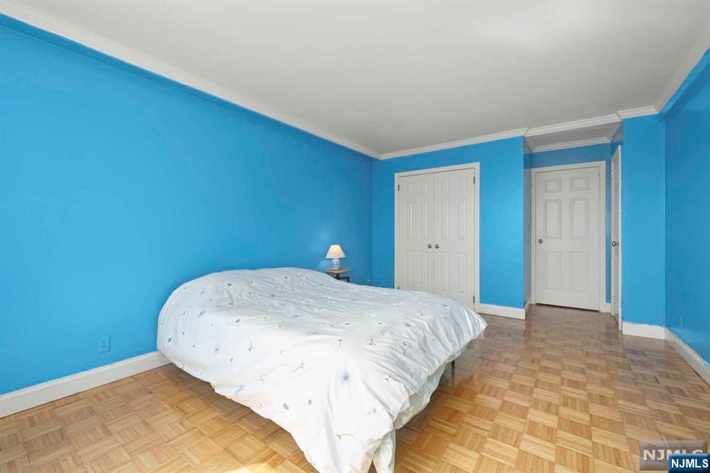 1375 River Road, Unit 4D Edgewater, NJ 07020 - Photo 20 of 25 a bedroom with a bed and a night stand