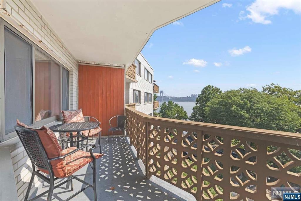 1375 River Road, Unit 4D Edgewater, NJ 07020 - Photo 21 of 25 a balcony with chairs and table