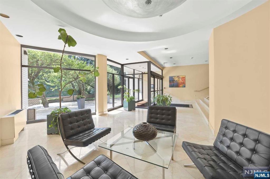 1375 River Road, Unit 4D Edgewater, NJ 07020 - Photo 4 of 25 a living room with furniture and a floor to ceiling window