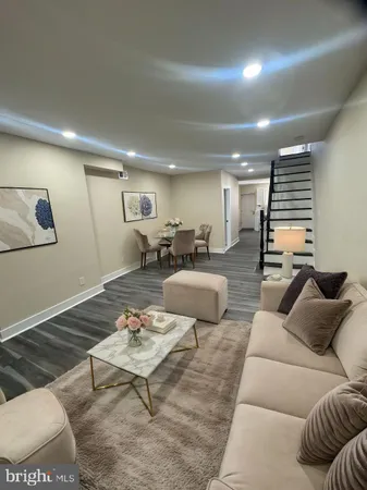 a living room with furniture and wooden floor