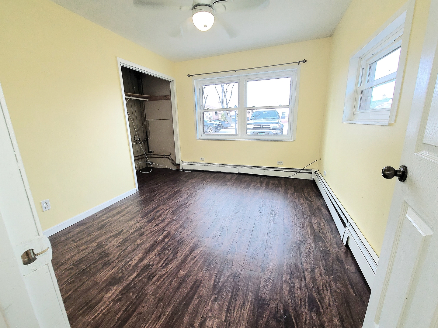 7807 Parkside Avenue Burbank, IL 60459 - Photo 13 of 23 an empty room with wooden floor and windows