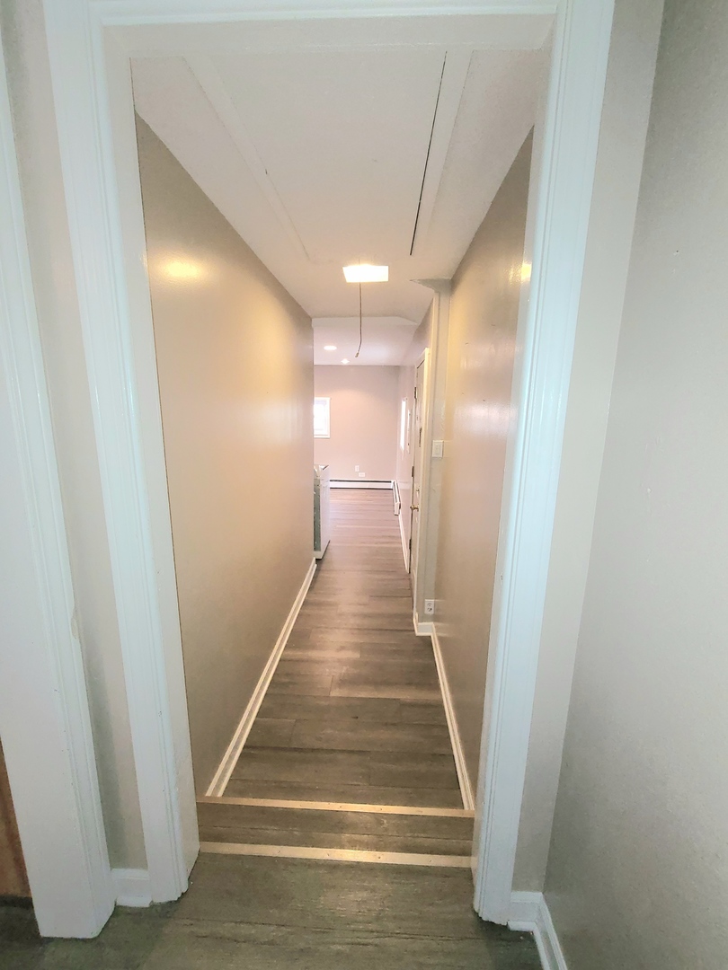 7807 Parkside Avenue Burbank, IL 60459 - Photo 15 of 23 a view of a hallway with wooden floor and entryway