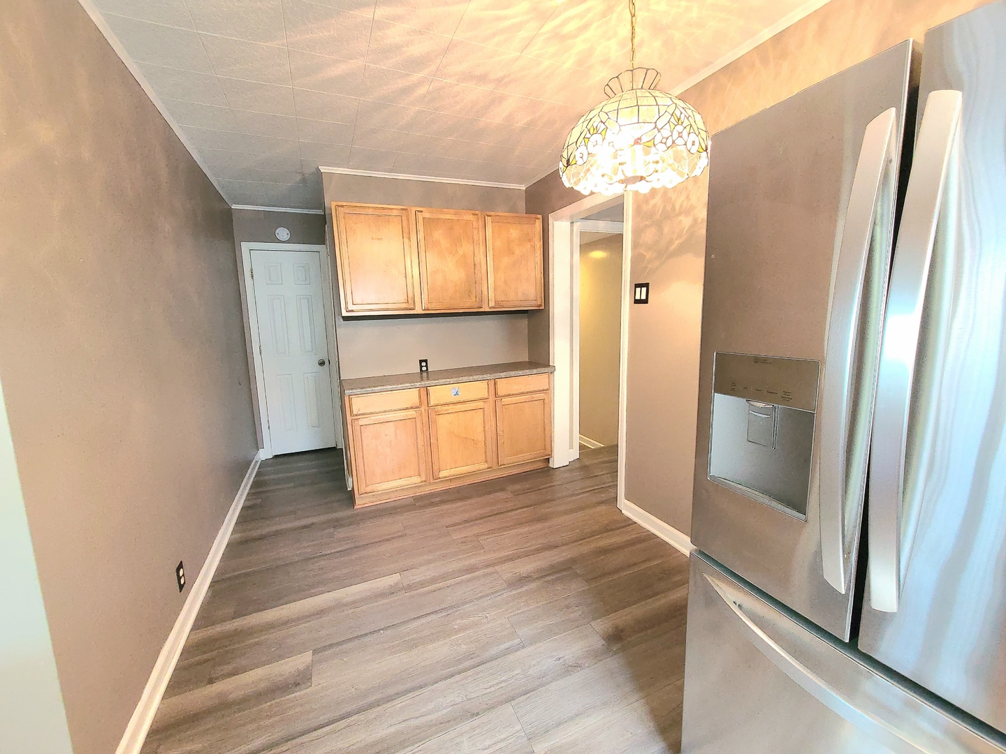 7807 Parkside Avenue Burbank, IL 60459 - Photo 7 of 23 a view of a hallway with wooden floor and cabinet
