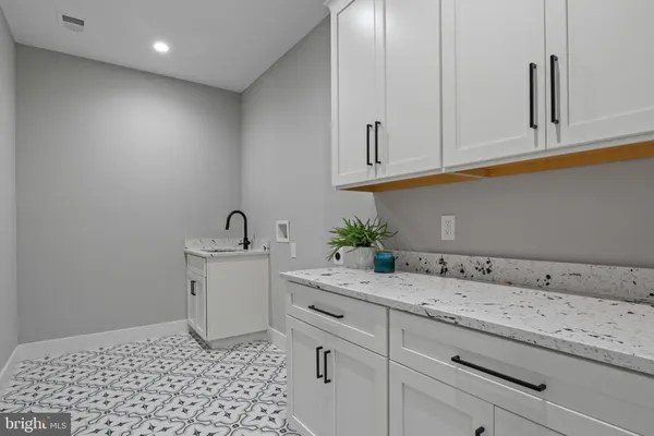 a kitchen with a sink and cabinets