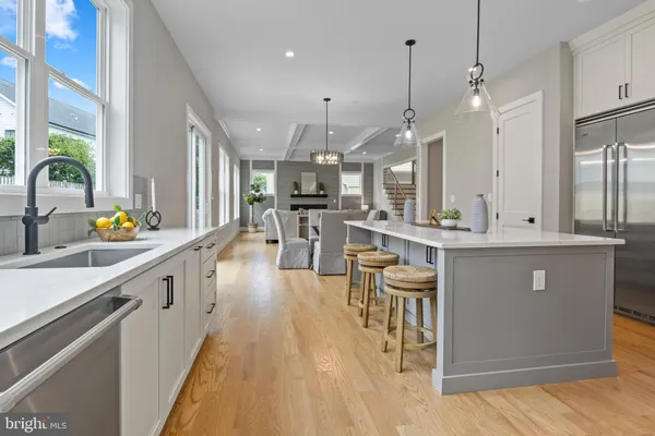 a large kitchen with stainless steel appliances kitchen island a large counter space a sink a counter space and a window