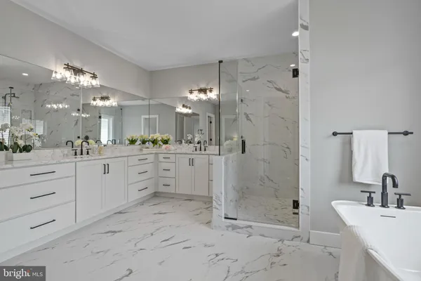 a spacious bathroom with a shower sink and mirror
