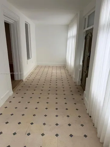 a living room with a table and chairs