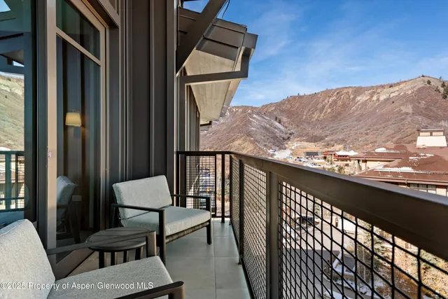 a bed room with two bed and a large window