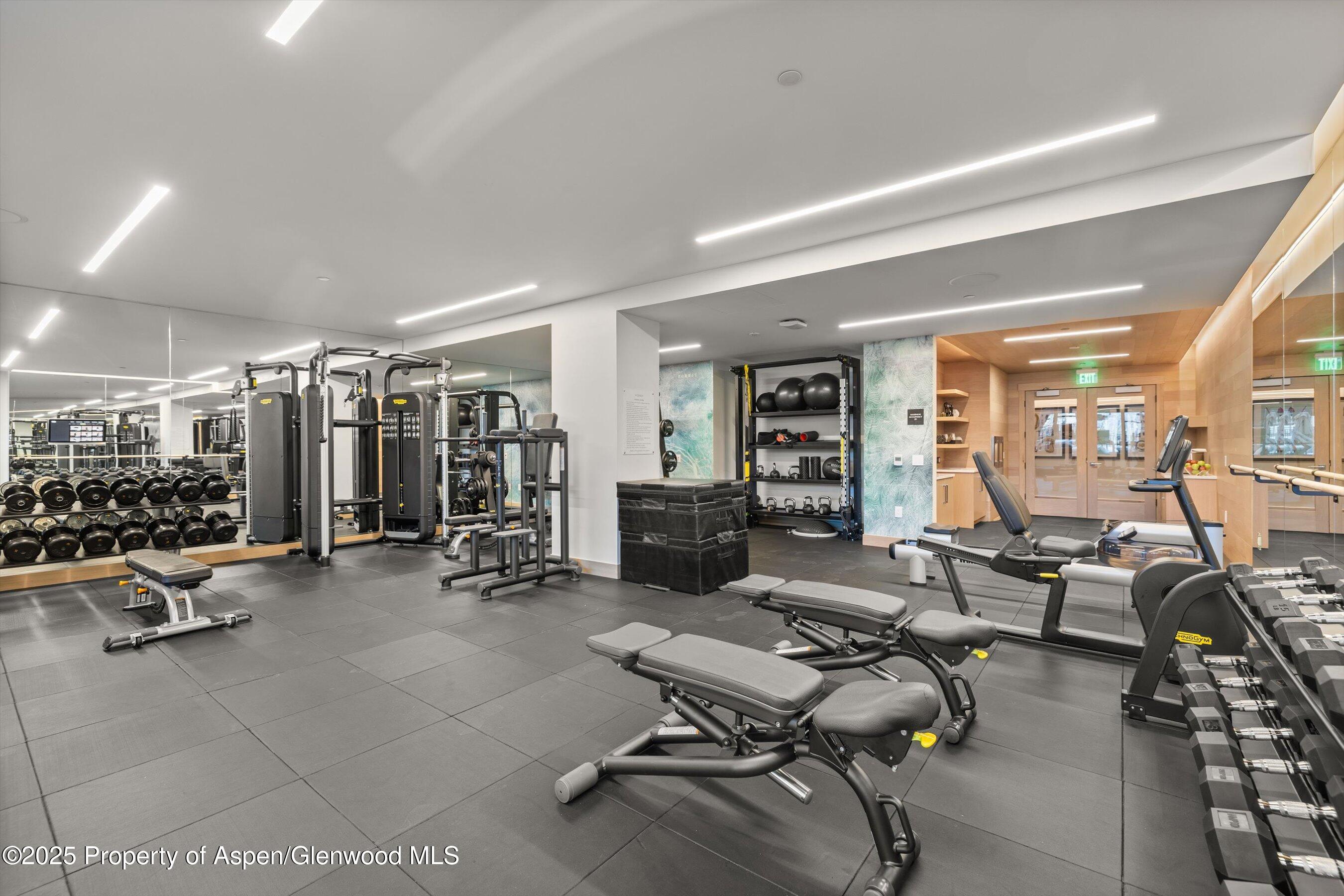 130 Wood Road, Unit 660662 Snowmass Village, CO 81615 - Photo 22 of 31 a view of a livingroom with lounge chair and a large window