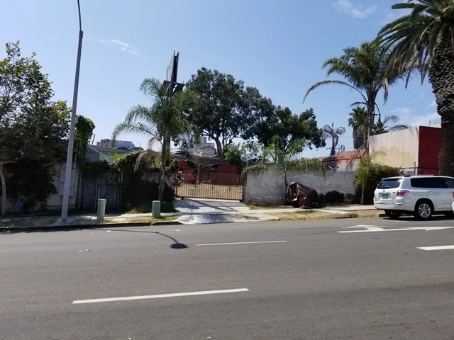a view of street along with palm trees