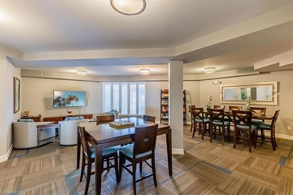 1100 Pine Ridge Road, Unit B106 Naples, FL 34108 - Photo 4 of 10 Carpeted dining area with baseboards
