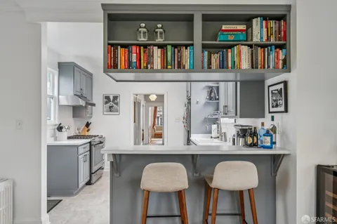a kitchen with a sink a stove and cabinets