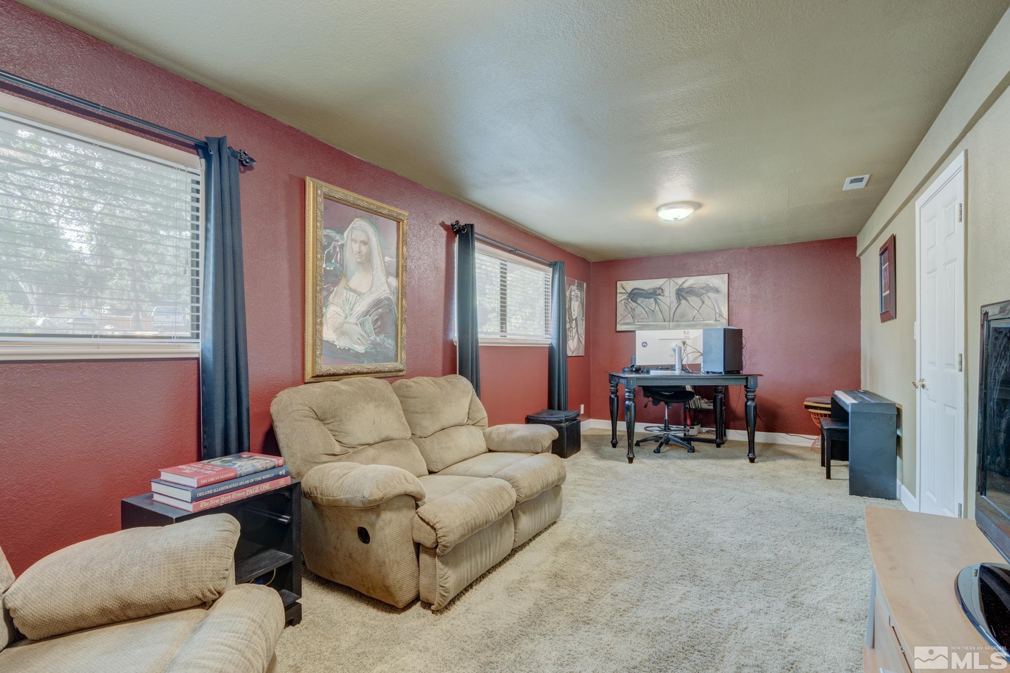 4185 Juniper Creek Road Reno, NV 89519 - Photo 11 of 40 a living room with furniture and a large window