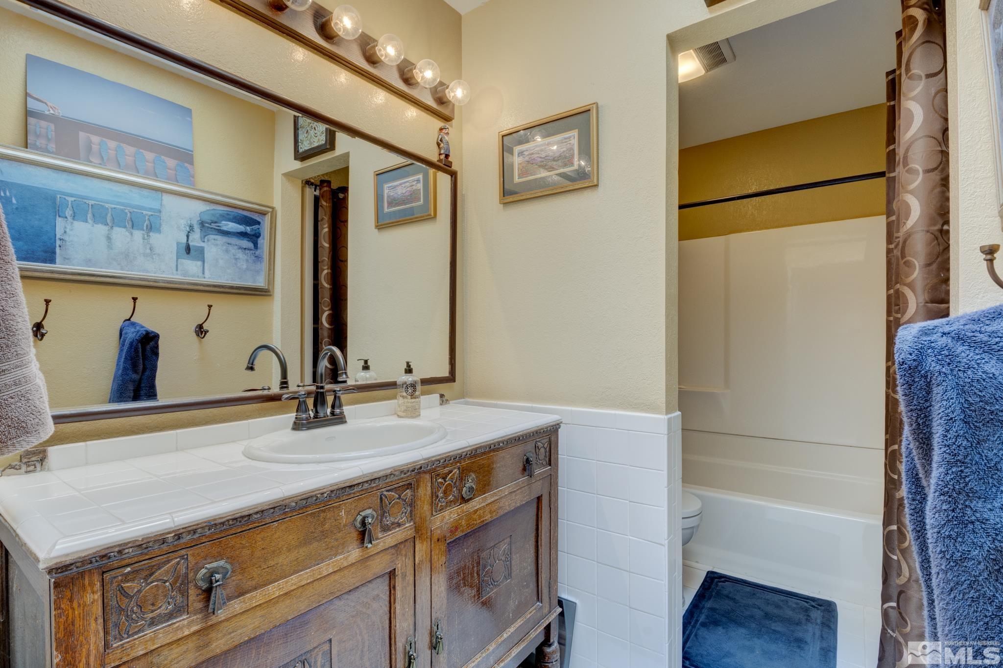 4185 Juniper Creek Road Reno, NV 89519 - Photo 21 of 40 a bathroom with a sink and a mirror