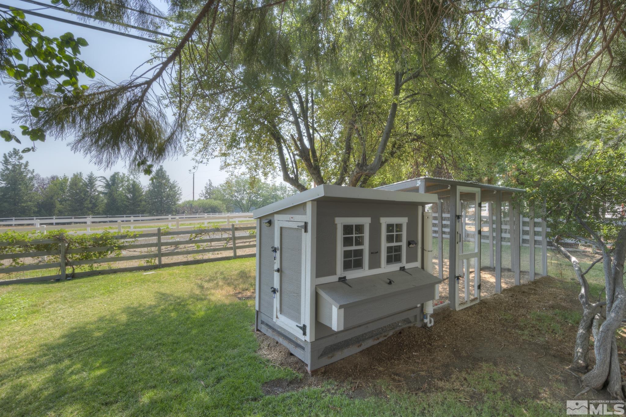 4185 Juniper Creek Road Reno, NV 89519 - Photo 33 of 40 a view of a house with a backyard and a large tree