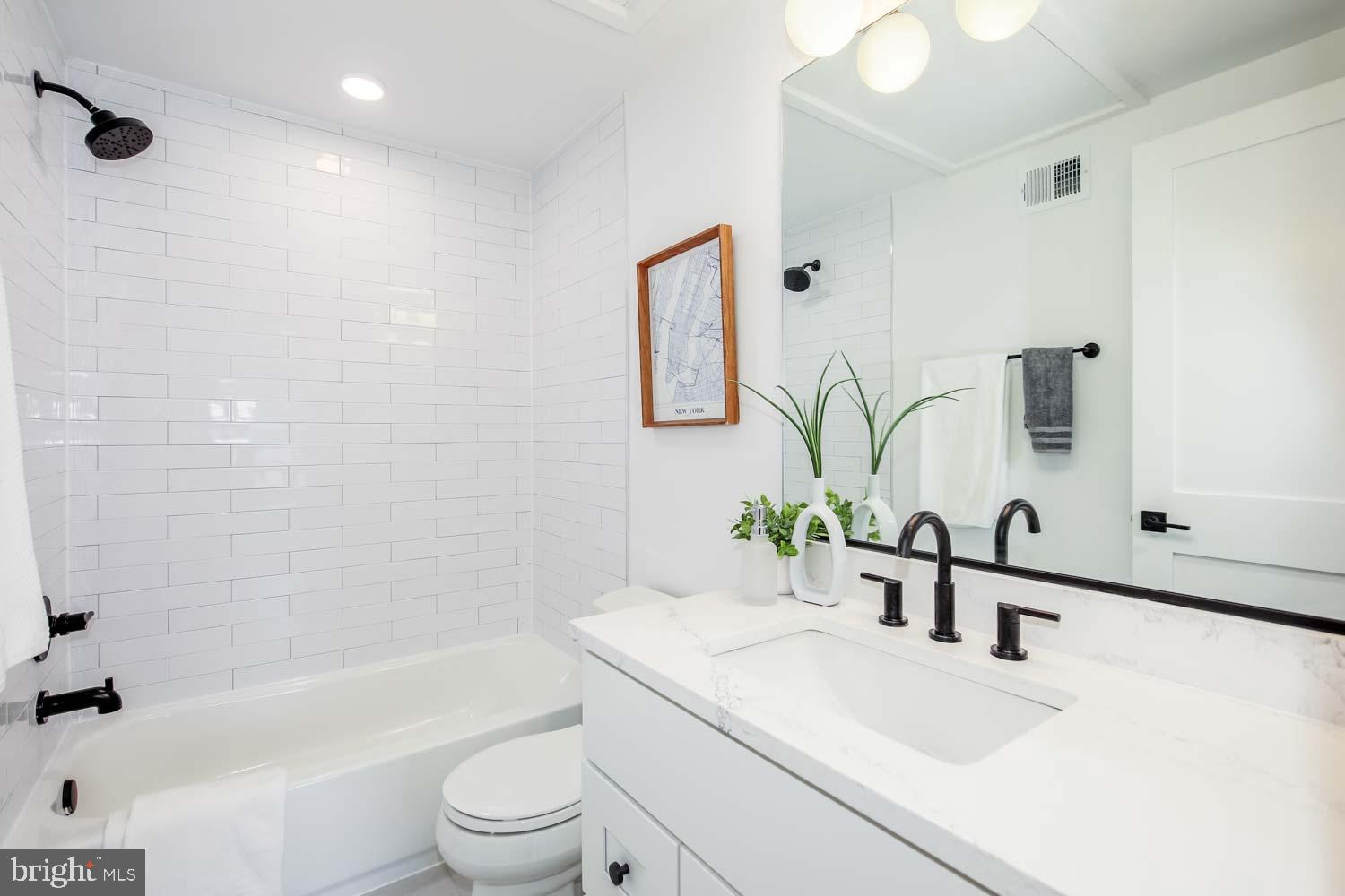 1818 Rhode Island Avenue Northeast, Unit 4 Washington, DC 20018 - Photo 11 of 15 a bathroom with a sink a toilet and bathtub