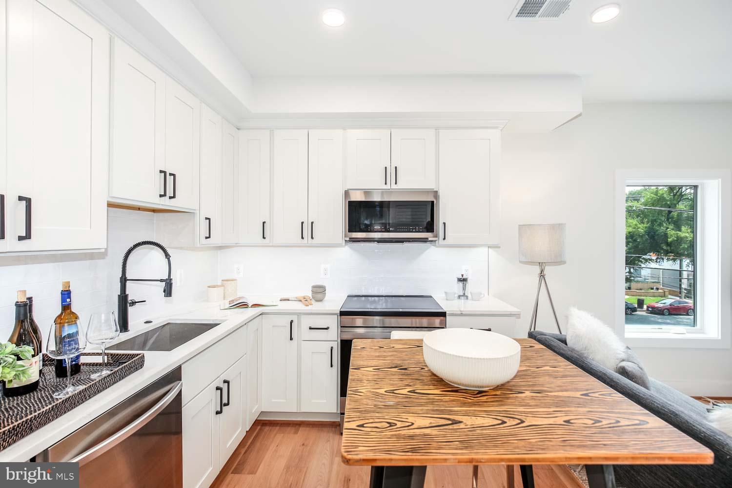1818 Rhode Island Avenue Northeast, Unit 4 Washington, DC 20018 - Photo 3 of 15 a kitchen with a sink a stove and cabinets