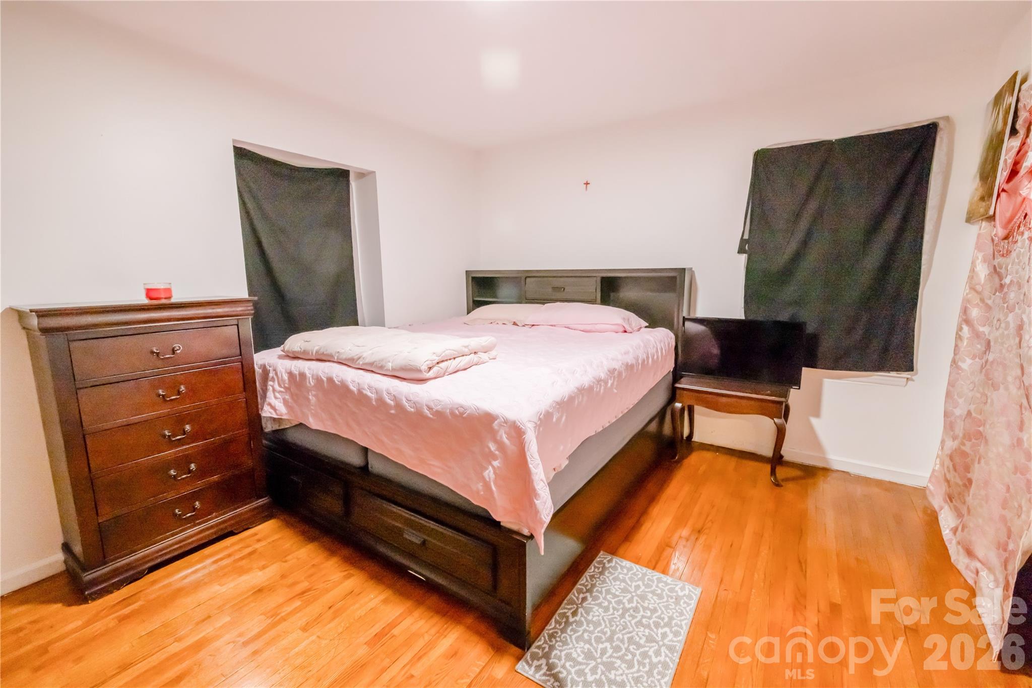 2545 Cedarwild Road Charlotte, NC 28212 - Photo 4 of 25 a bed room with a bed and a mirror