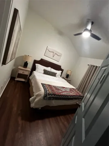 a bed sitting in a bedroom next to a larger window