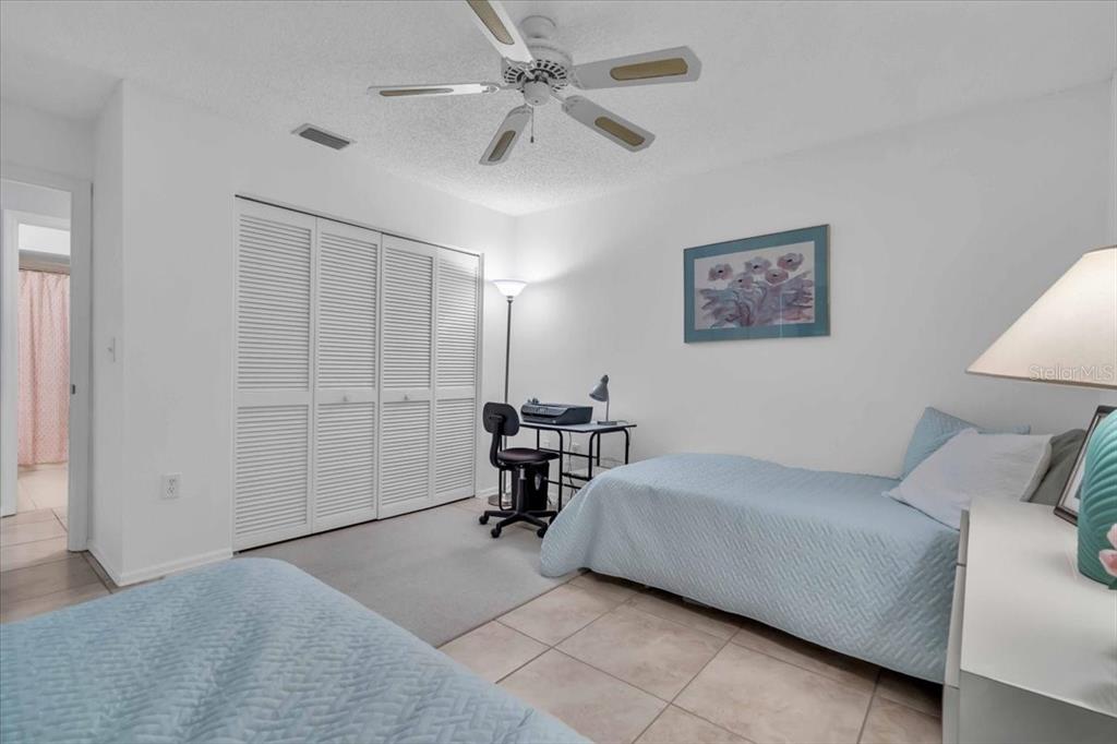 6807 Stone River Road, Unit 204 Bradenton, FL 34203 - Photo 12 of 54 a bedroom with a bed a desk and chair