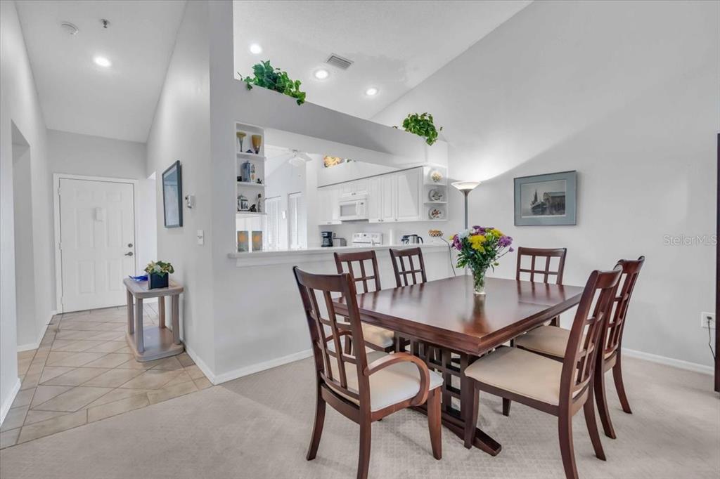 6807 Stone River Road, Unit 204 Bradenton, FL 34203 - Photo 19 of 54 a view of a dining room with furniture and wooden floor