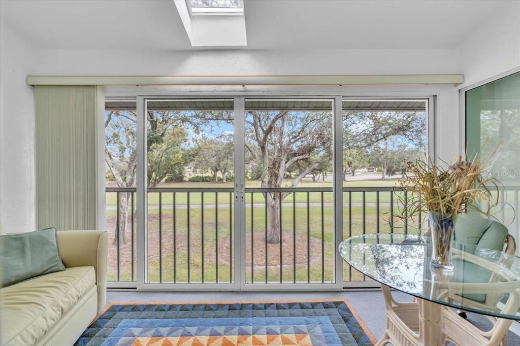 6807 Stone River Road, Unit 204 Bradenton, FL 34203 - Photo 29 of 54 a living room with furniture and a floor to ceiling window
