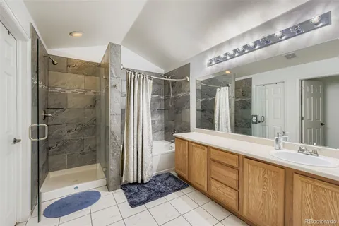 a bathroom with a shower sink and mirror