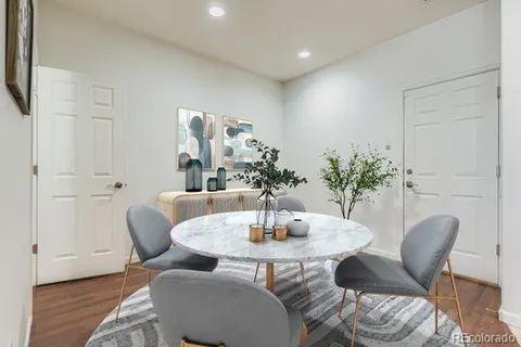 a dining room with furniture and wooden floor