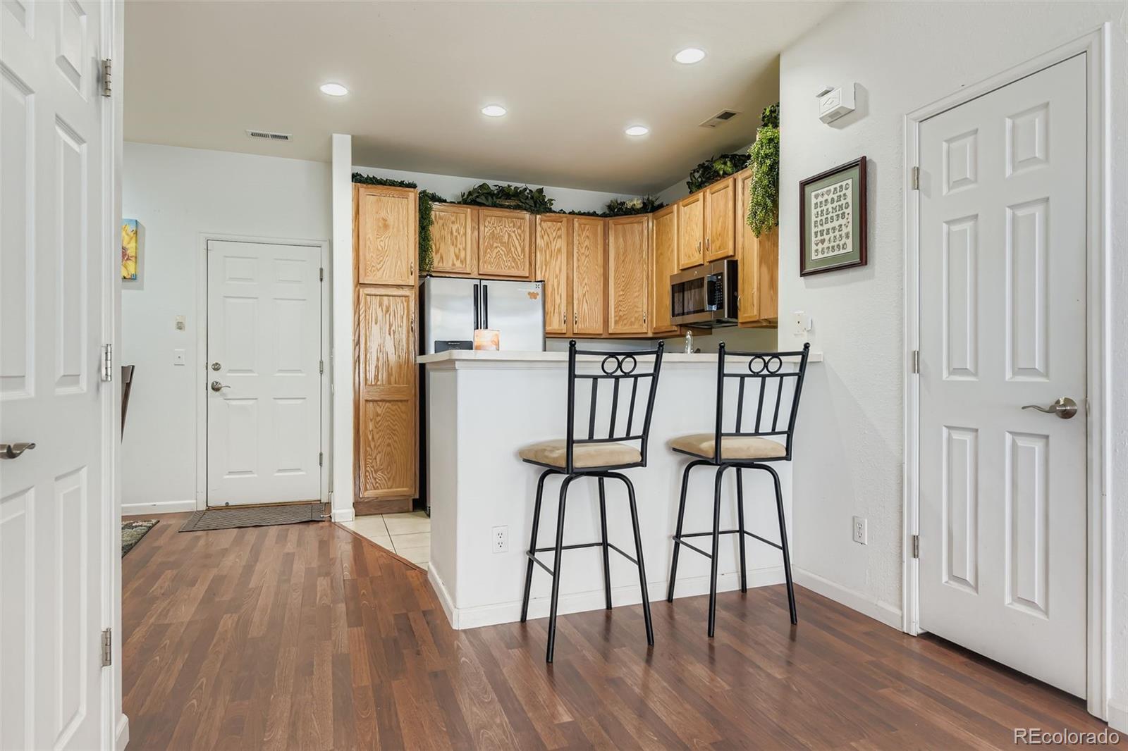 8320 Stonybridge Circle Littleton, CO 80126 - Photo 4 of 11 a view of a kitchen with furniture and wooden floor