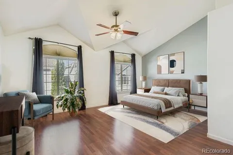 a bedroom with a bed and a potted plant