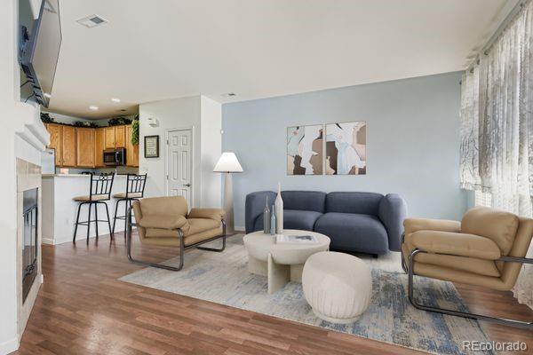 8320 Stonybridge Circle Littleton, CO 80126 - Photo 7 of 11 a living room with furniture and a wooden floor