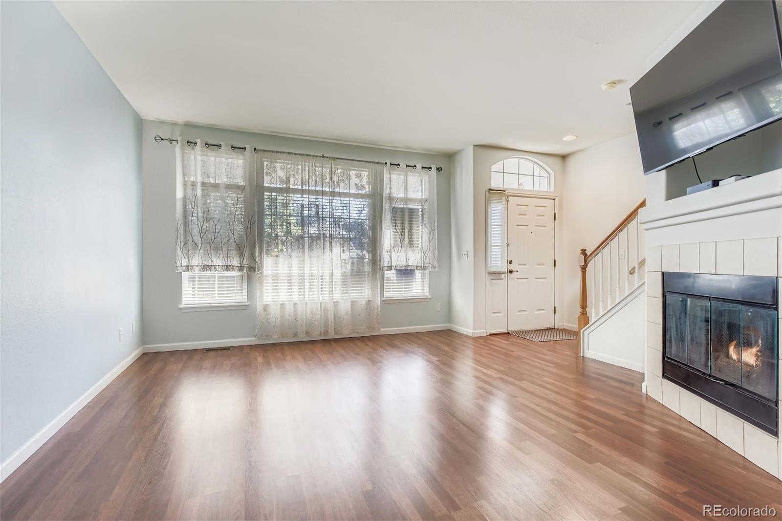 8320 Stonybridge Circle Littleton, CO 80126 - Photo 8 of 11 a view of empty room with wooden floor and fireplace