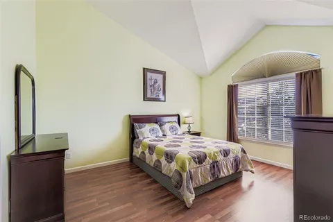a bedroom with a bed table and a window