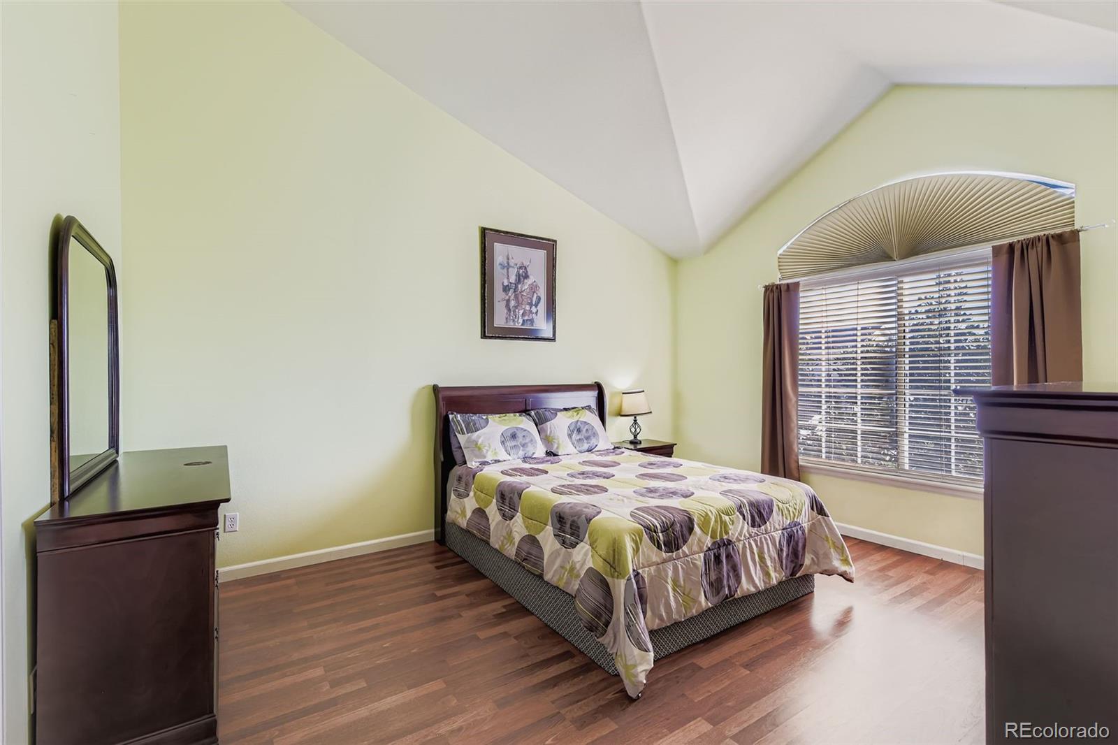 8320 Stonybridge Circle Littleton, CO 80126 - Photo 10 of 11 a bedroom with a bed table and a window