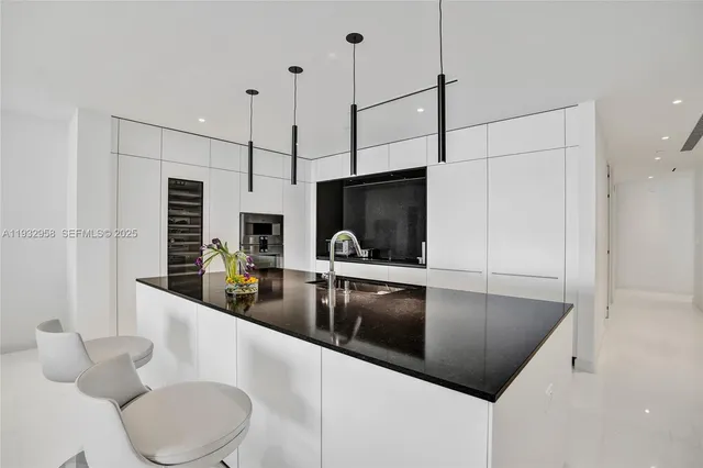 a bathroom with a sink and glass door shower