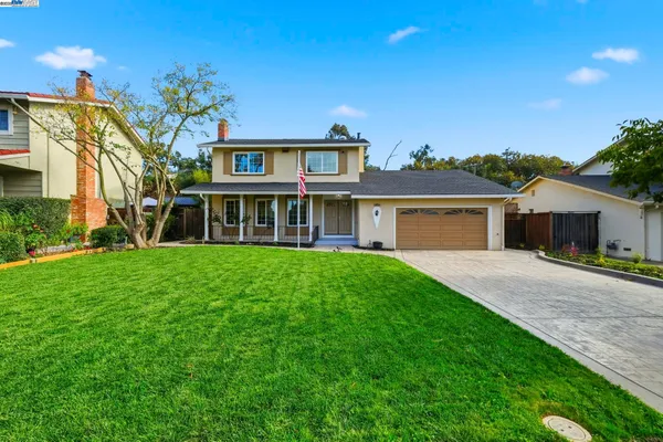 a front view of house with yard and green space