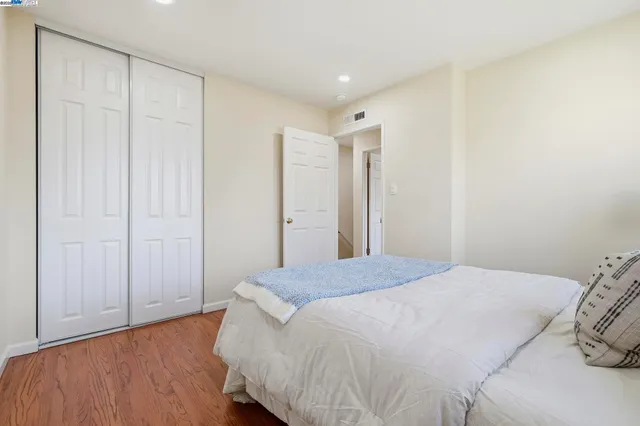 a spacious bedroom with a bed and a table