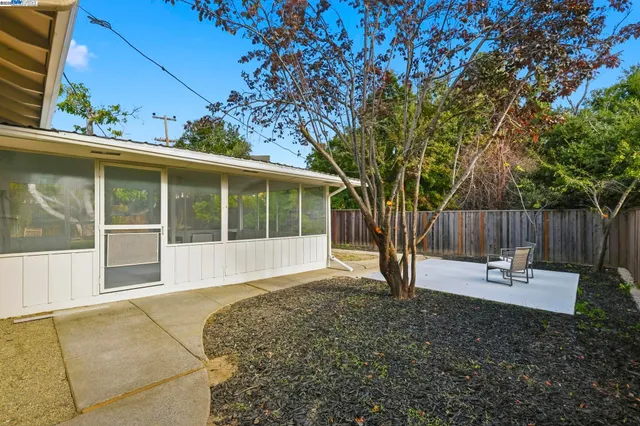 a view of a house with wooden fence